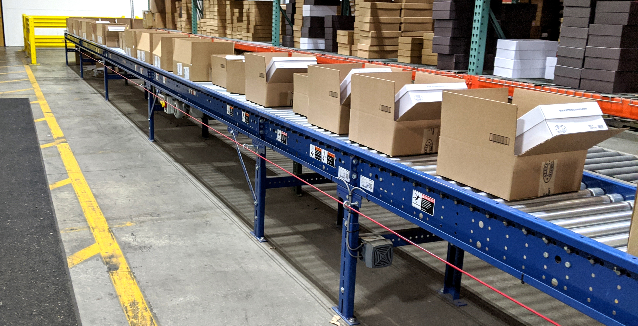 UDS automated conveyor system processing cartons for retail distribution